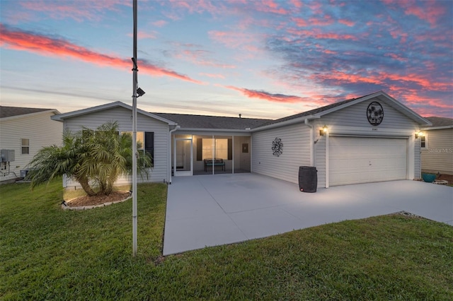 view of front of home featuring a garage and a lawn