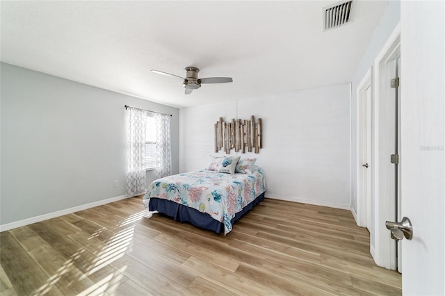 bedroom with hardwood / wood-style floors and ceiling fan