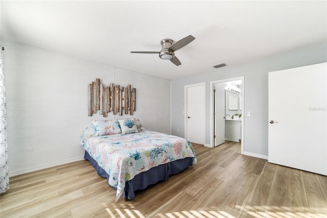 bedroom featuring hardwood / wood-style flooring, ceiling fan, and ensuite bath