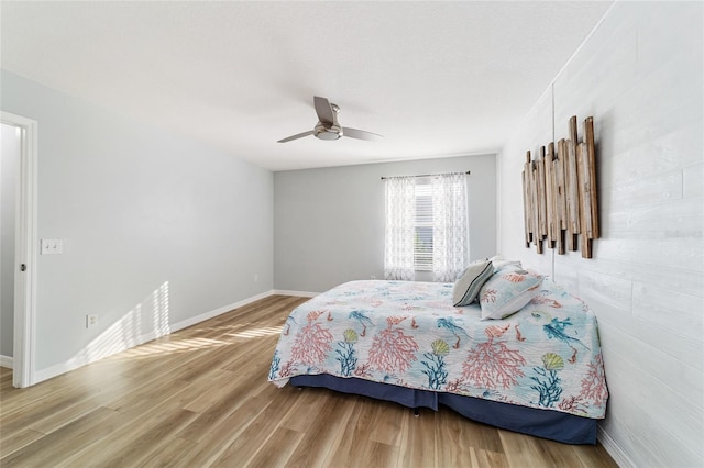 bedroom with wood-type flooring and ceiling fan