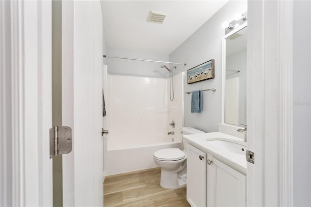 full bathroom with vanity,  shower combination, hardwood / wood-style flooring, toilet, and a textured ceiling