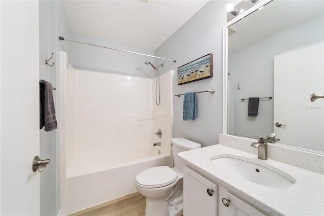 full bathroom featuring hardwood / wood-style floors, shower / bath combination, a textured ceiling, toilet, and vanity