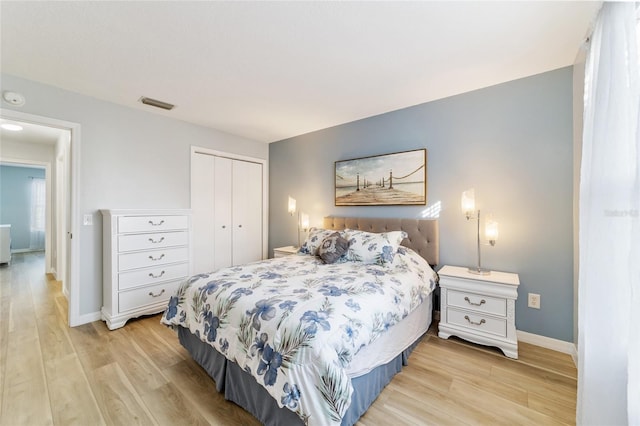 bedroom featuring a closet and light hardwood / wood-style flooring