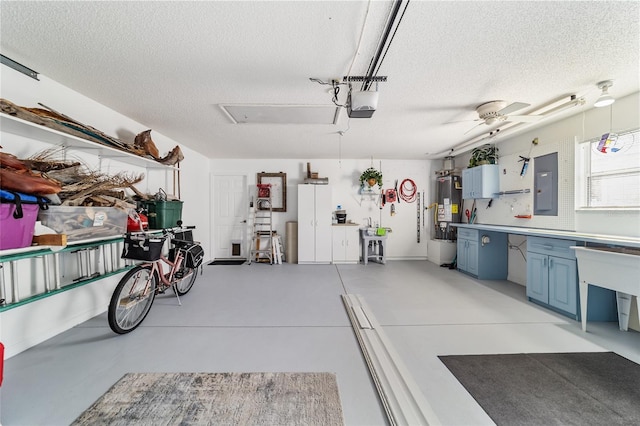 garage with electric panel, water heater, ceiling fan, and a garage door opener