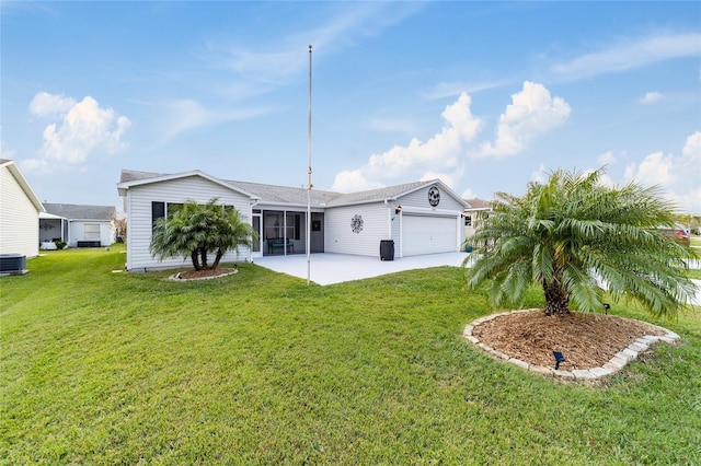 exterior space with a lawn, central AC, and a garage