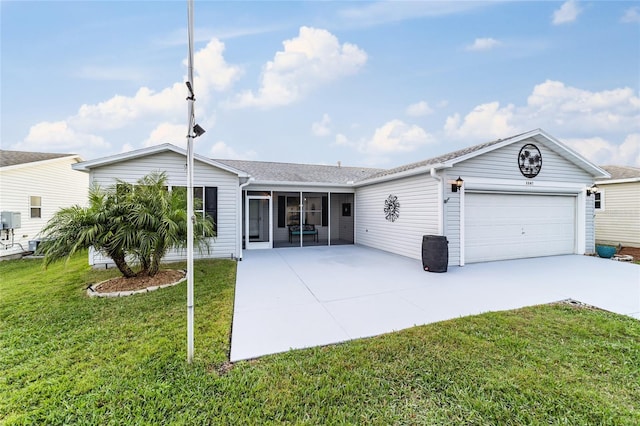 rear view of property with a lawn and a garage