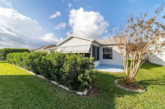 view of home's exterior featuring a lawn and a patio