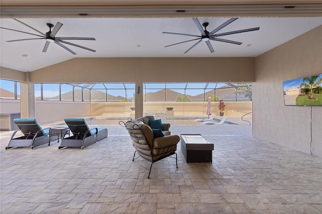 view of patio featuring glass enclosure and ceiling fan