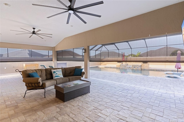 view of patio with outdoor lounge area, a pool with hot tub, ceiling fan, and glass enclosure