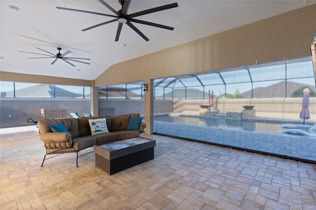 view of patio featuring outdoor lounge area, a mountain view, a lanai, and a jacuzzi