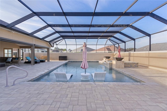 view of swimming pool featuring pool water feature, an outdoor hangout area, glass enclosure, and a patio area