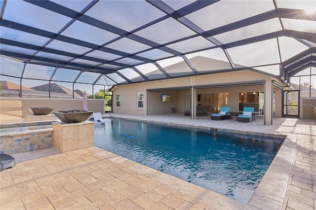 view of swimming pool featuring a lanai, a patio area, and outdoor lounge area