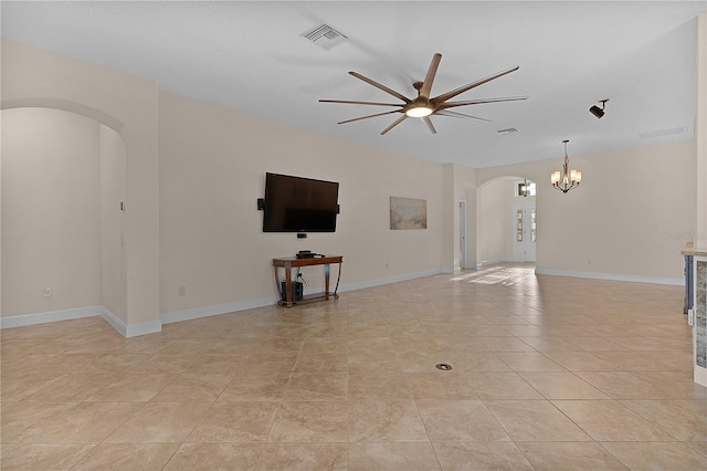 unfurnished living room featuring light tile patterned flooring and ceiling fan with notable chandelier