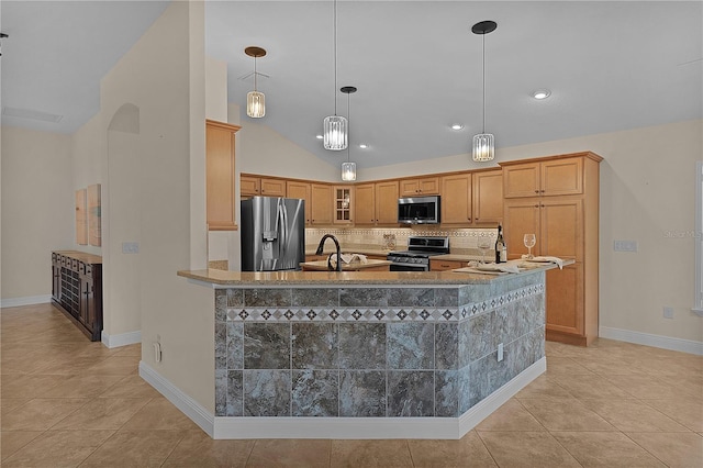 kitchen with appliances with stainless steel finishes, backsplash, sink, light tile patterned floors, and decorative light fixtures