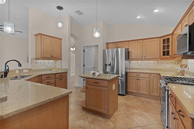 kitchen with decorative backsplash, appliances with stainless steel finishes, pendant lighting, and sink