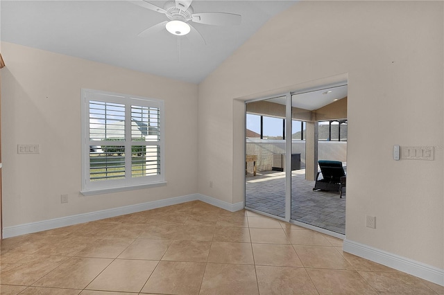 spare room featuring ceiling fan, light tile patterned flooring, and lofted ceiling