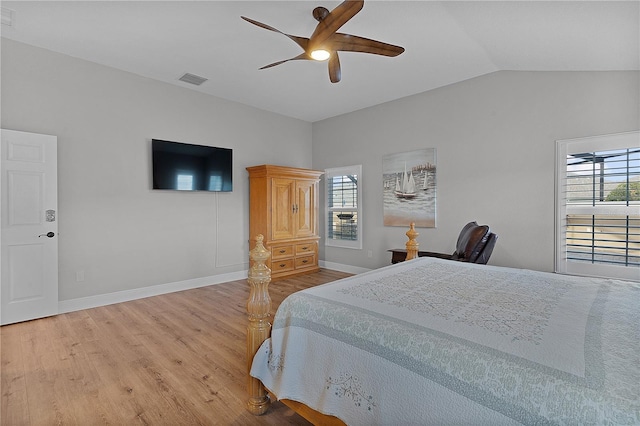 bedroom with multiple windows, wood-type flooring, vaulted ceiling, and ceiling fan