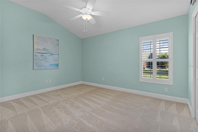 carpeted spare room featuring ceiling fan and lofted ceiling