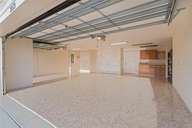 garage with electric panel and a garage door opener