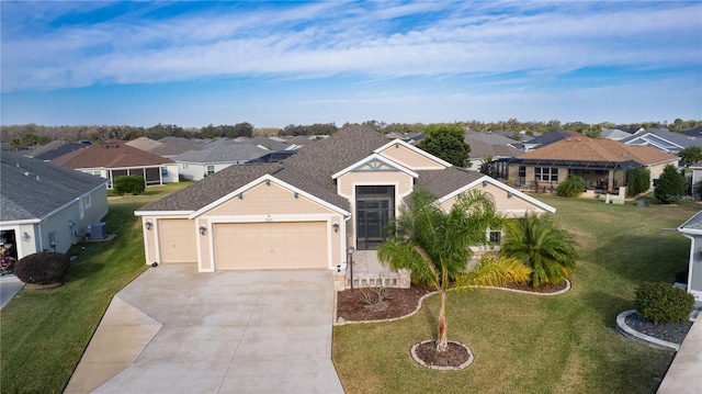 view of front of house featuring central air condition unit, a front lawn, and a garage