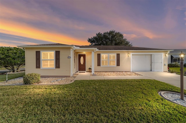 single story home with a lawn and a garage