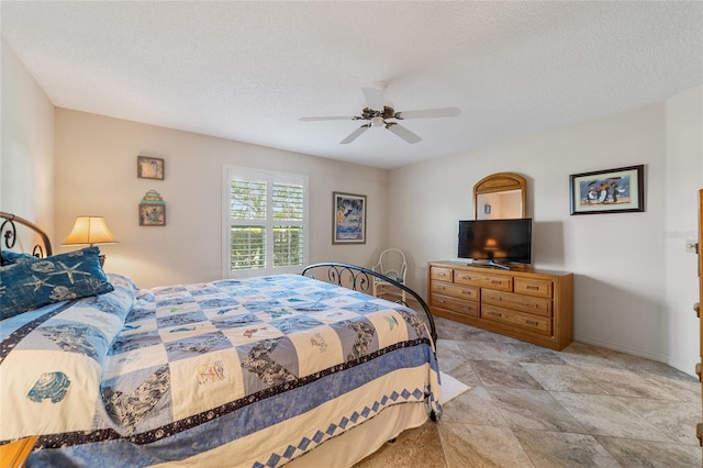 bedroom featuring a textured ceiling and ceiling fan