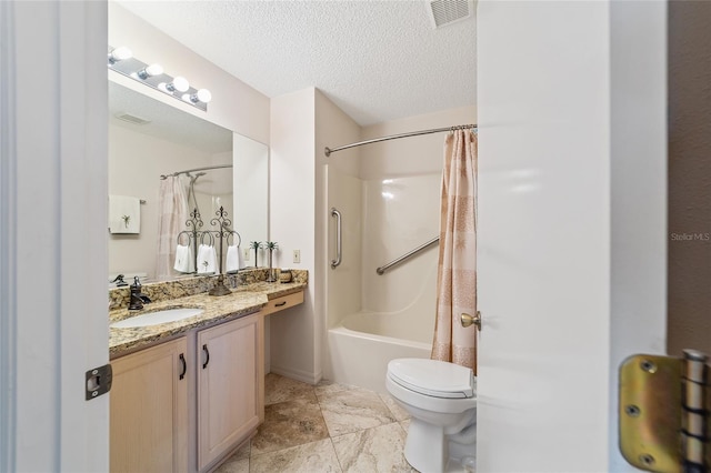 full bathroom with shower / tub combo with curtain, vanity, a textured ceiling, and toilet