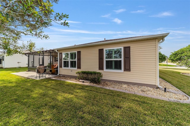 rear view of property featuring a patio area and a yard