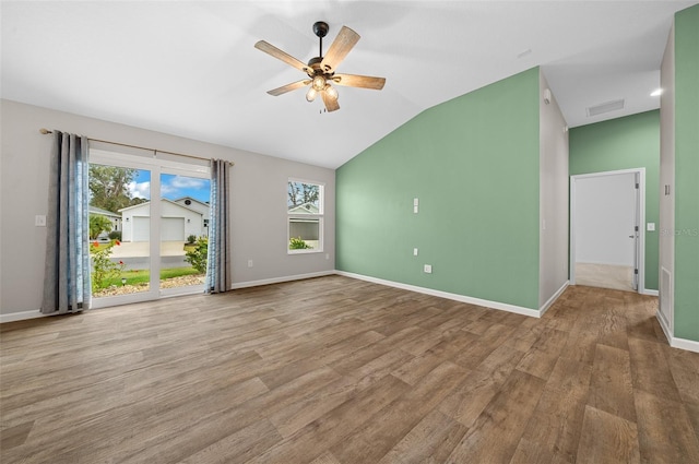 unfurnished room with ceiling fan, light hardwood / wood-style floors, and vaulted ceiling