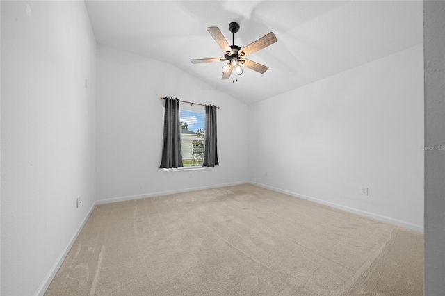 carpeted empty room with ceiling fan and vaulted ceiling