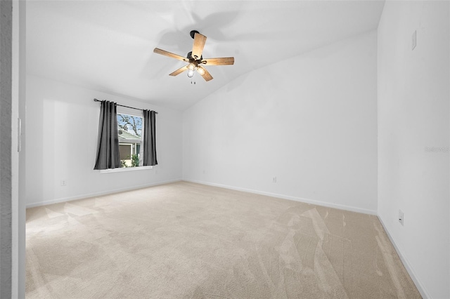 carpeted empty room featuring ceiling fan and lofted ceiling