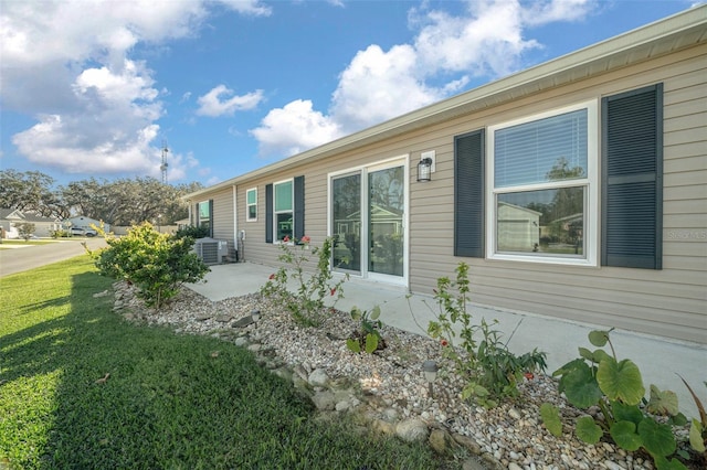 view of property exterior with a lawn