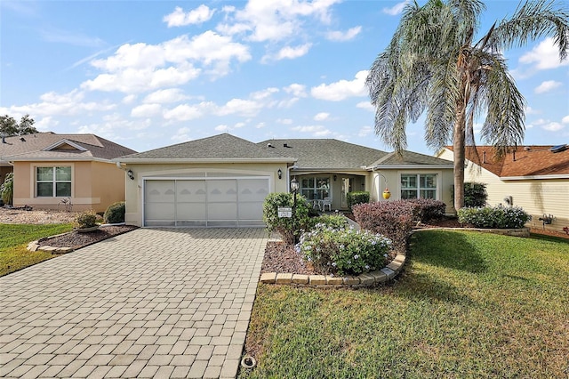 single story home featuring a front yard and a garage