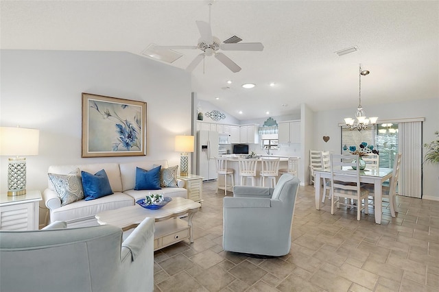 living room featuring ceiling fan with notable chandelier and vaulted ceiling