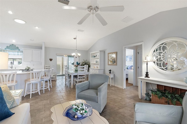 living room with ceiling fan with notable chandelier and lofted ceiling