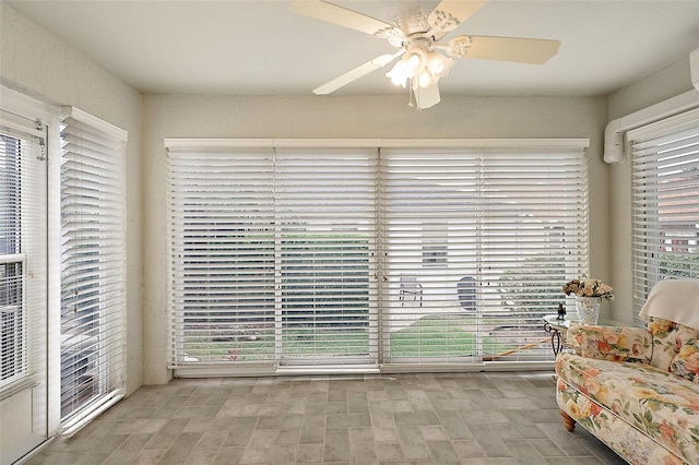 sunroom with ceiling fan and a healthy amount of sunlight