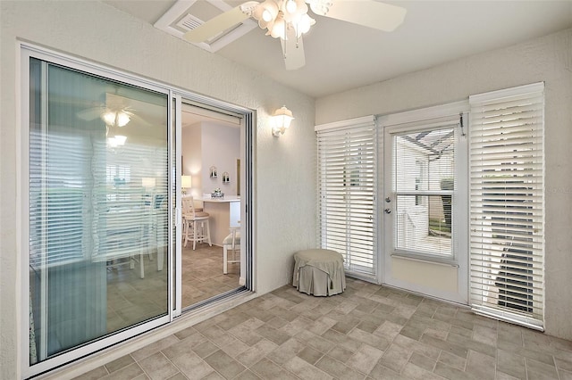 doorway featuring ceiling fan