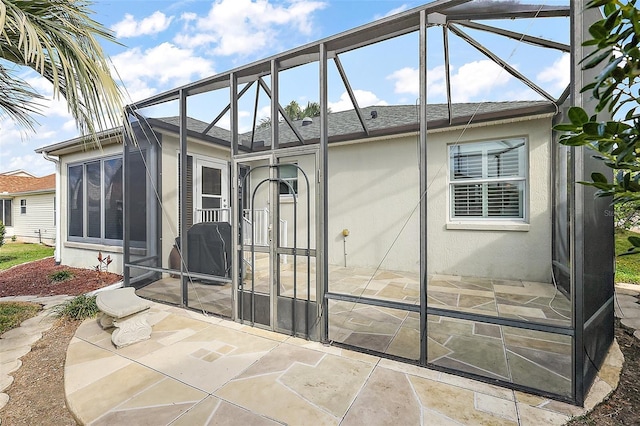 back of house with a lanai and a patio