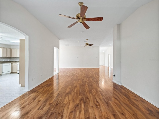 unfurnished living room with ceiling fan, light hardwood / wood-style flooring, and vaulted ceiling