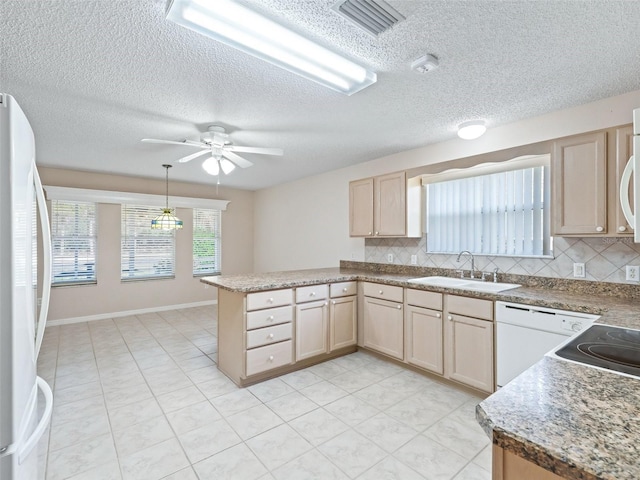 kitchen featuring sink, light brown cabinets, tasteful backsplash, kitchen peninsula, and white appliances