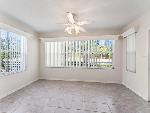 spare room featuring ceiling fan and light tile patterned flooring