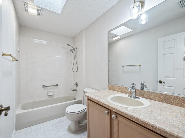 full bathroom with a skylight, shower / bathing tub combination, vanity, and toilet