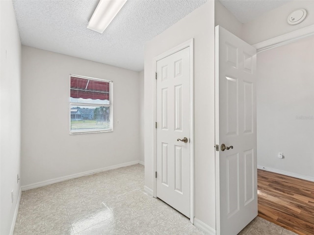 unfurnished bedroom featuring a textured ceiling