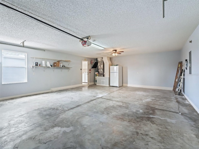 garage featuring electric panel, ceiling fan, white fridge, and a garage door opener