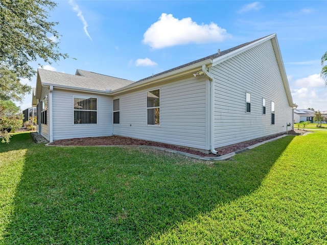 rear view of property with a lawn