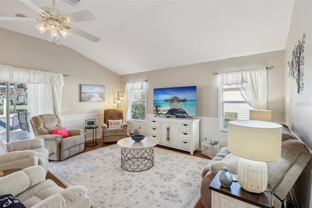 living room featuring a wealth of natural light, light hardwood / wood-style flooring, ceiling fan, and lofted ceiling