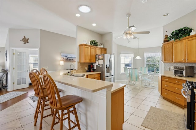 kitchen with stainless steel appliances, light countertops, a sink, and light tile patterned floors