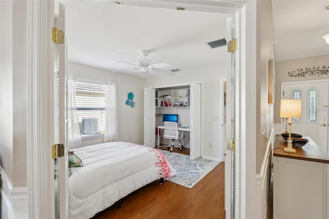 bedroom featuring ceiling fan, wood finished floors, and visible vents