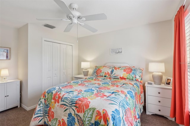 carpeted bedroom featuring a closet, visible vents, and ceiling fan