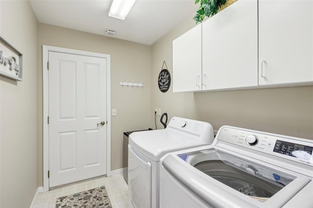 laundry room featuring cabinets and independent washer and dryer